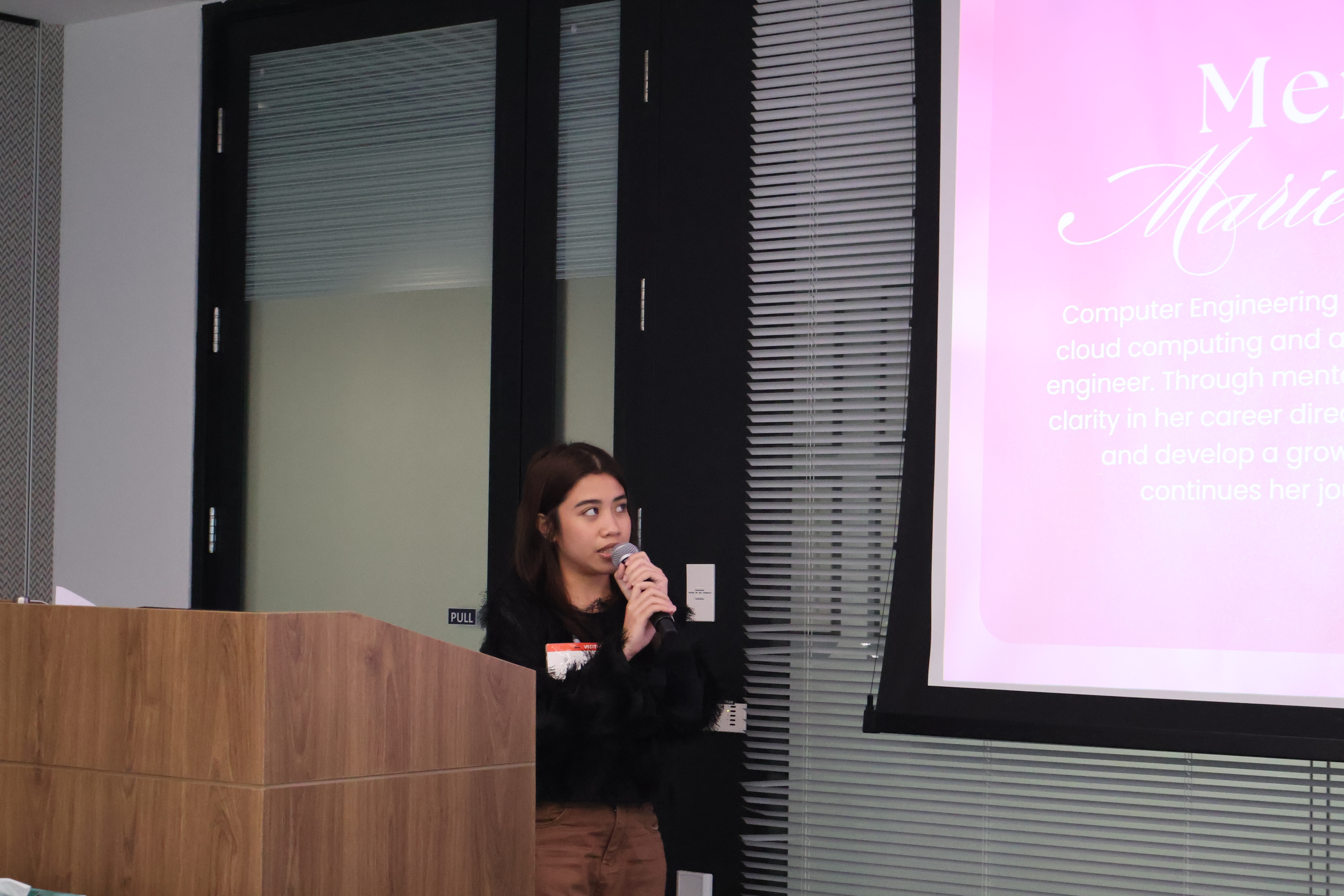 Marielle speaking at BuildHers+ PH podium